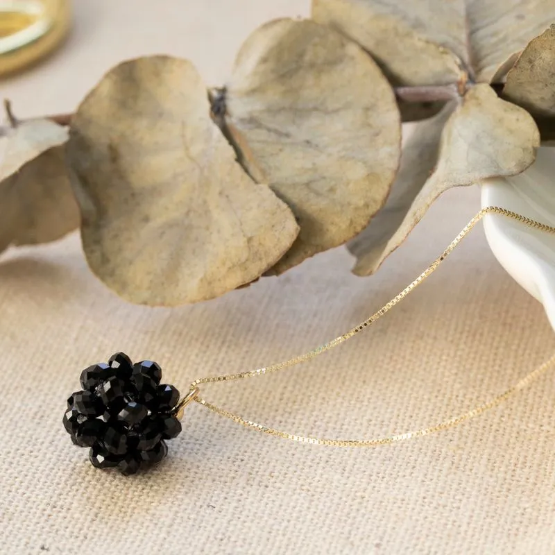 Ball-shaped black bead pendant with gold hanger