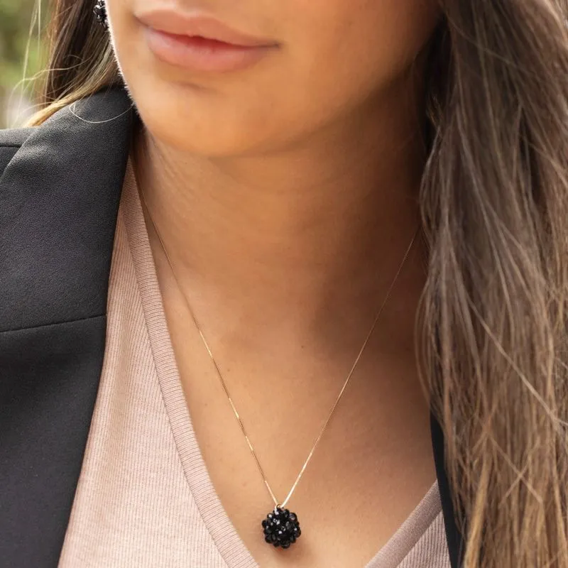 Ball-shaped black bead pendant with gold hanger